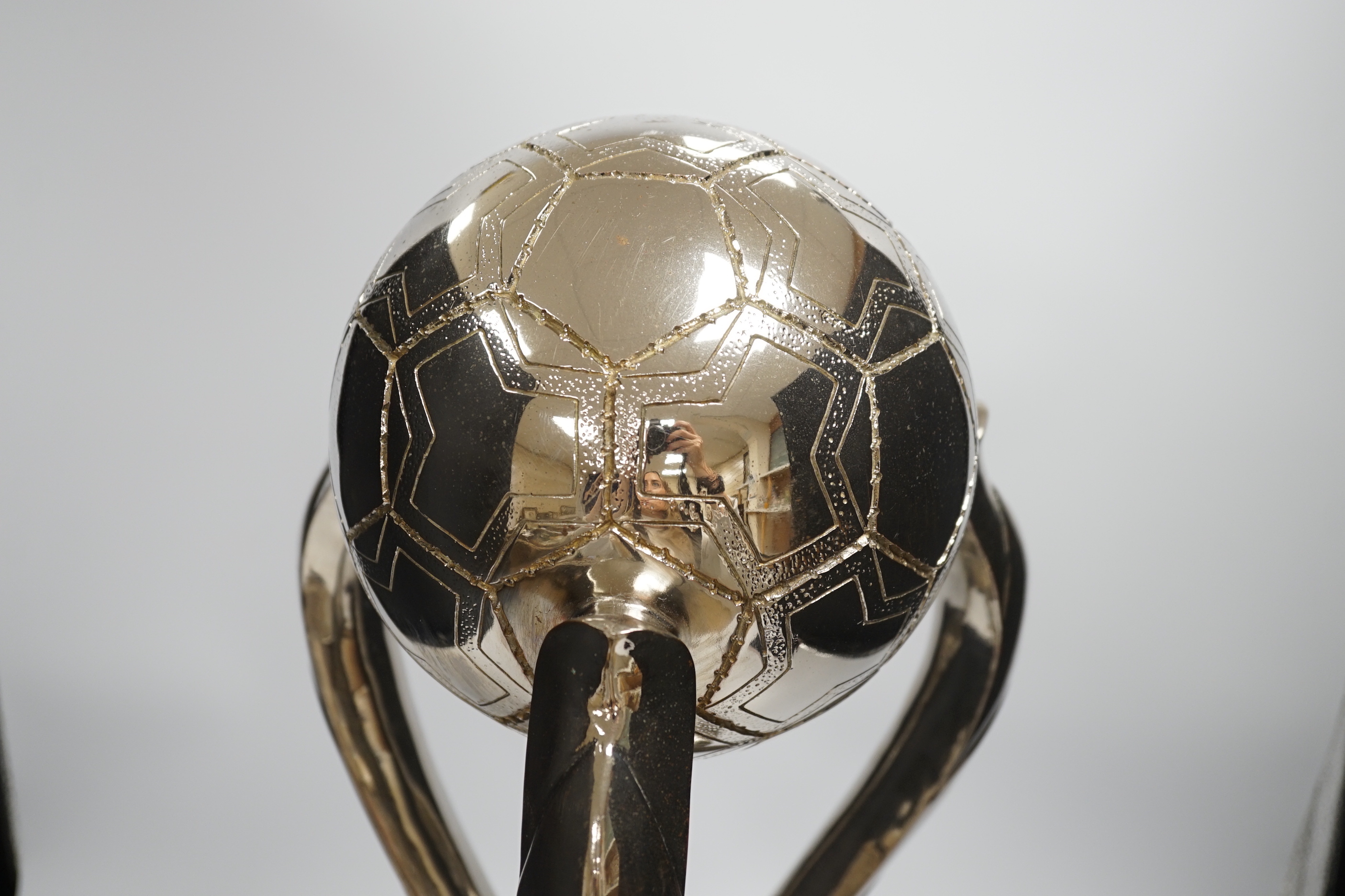 A chrome-plated football trophy, 51cm high